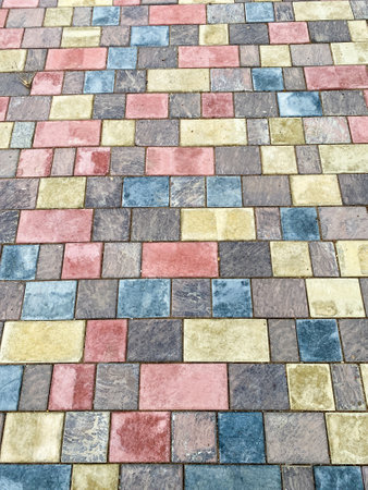 The sidewalk showcases stunning symmetrical brickwork that enhances its beauty, emphasizing the charming pattern created by the bricks. It adds to the aesthetic appeal of the areaの写真素材
