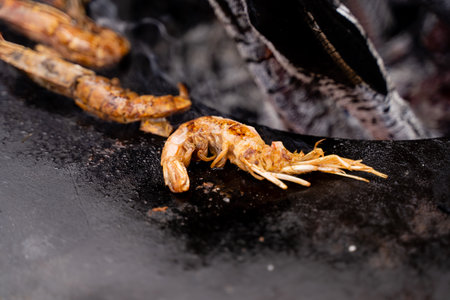Savory grilled shrimp beautifully resting on a sizzling hot plate, showcasing a truly delicious culinary experience that is perfect for devoted seafood lovers everywhereの写真素材