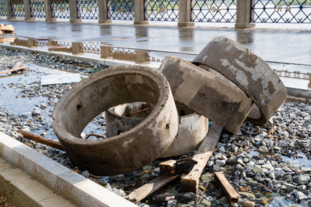 Concrete rings and debris now cover a once functional pathway, highlighting ongoing urban neglect...
