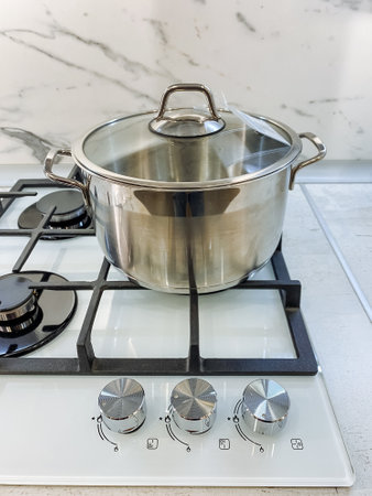 A pot filled with water is currently boiling on a gas stove, which is a common kitchen appliance used for cooking various meals. This pot is typically made of cookware and bakeware materialsの写真素材