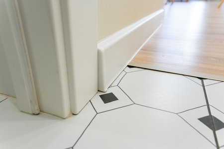 A stylish view featuring contemporary floor tiles paired with elegant door trim, showcasing modern design elements in a welllit room that significantly enhances aesthetic appealの写真素材