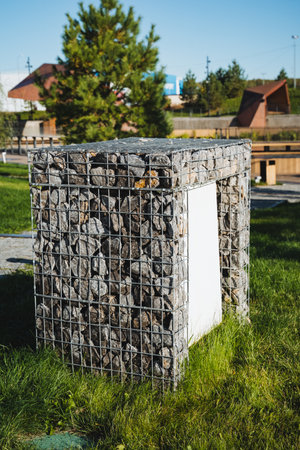 In a peaceful park, there is a sturdy fence constructed from various rocks, resting gracefully on the lush green grass that surrounds it, creating a natural and beautiful landscapeの写真素材