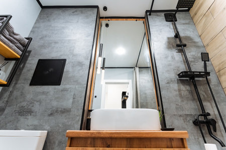 This beautifully designed and stylish bathroom showcases a sleek modern sink, an elegantly framed...