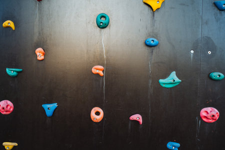 A vibrant and dynamic climbing wall that is adorned with an array of colorful rocks and holds, making it visually striking and highly attractive to climbers of all abilities and skill levelsの写真素材