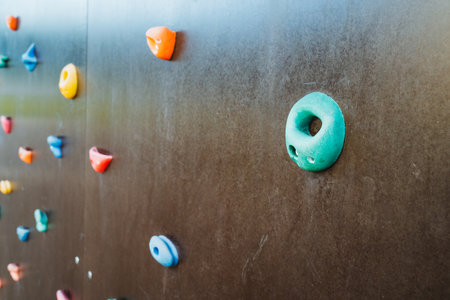 This is a detailed closeup image of a climbing wall that features a noticeable hole located right in the center of it, capturing the intricacies of the surface and the surrounding areasの写真素材