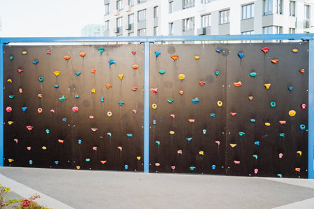 A climbing wall with a lot of climbing holds on itの写真素材