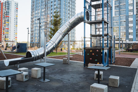 A lively playground that various features tables and chairs, ideal for relaxing, along with an exciting slide for children to enjoy and have fun on while playing with their friendsの写真素材