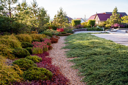 In the foreground, there is a beautiful garden filled with a variety of plants and trees, while a...