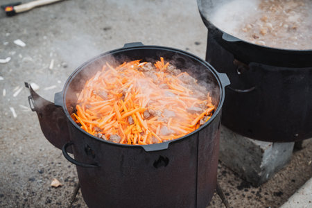 A large pot filled with vibrant carrots simmers in bubbling water, cooking for the perfect texture and flavor, ensuring a delightful dish for a lovely gathering of friends and familyの写真素材