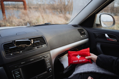 A first aid kit is conveniently stored in a cars dashboard, emphasizing how crucial it is to be well...