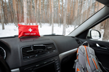 A first aid kit is conveniently located on the dashboard of a car, allowing it to be easily accessed in the event of emergencies that may arise while driving or traveling on the roadの写真素材