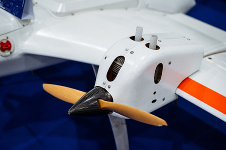 This captivating image shows a closeup of a stunning model airplane, focusing on its rapidly spinning propeller and showing the intricate design and engineering details of the aircraftの写真素材