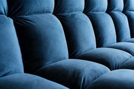 A stylish row of luxurious blue velvet chairs is neatly organized in a straight line, showcasing their elegant design and vivid electric blue hue, making a striking visual statementの写真素材