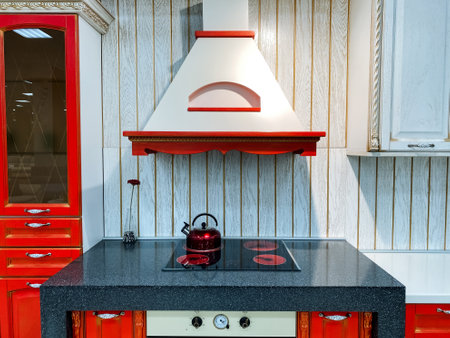 Imagine a beautifully designed kitchen featuring striking red cabinets that catch your eye, alongside a modern stove top oven that enhances the cooking experience and overall functionalityの写真素材