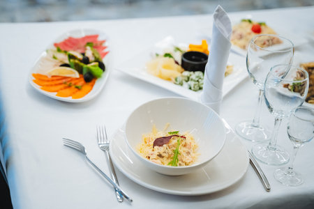 There is a beautifully arranged table featuring various plates of delicious food along with an...