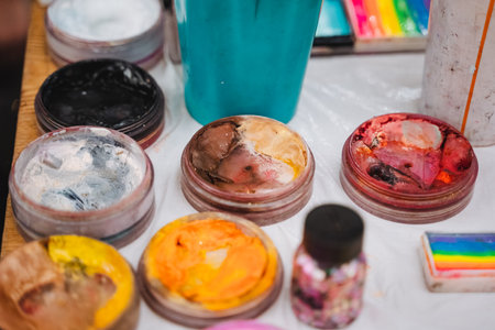 A beautifully arranged table is elegantly topped with an impressive and diverse variety of colorful face paints, showcasing an artistic array that delights the eyes and sparks boundless imaginationの写真素材