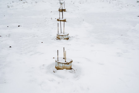 A few scattered pieces of cold, hard metal are currently resting on top of the pristine, white snow, surrounded by the beautiful and serene winter landscape that evokes a sense of tranquilityの写真素材