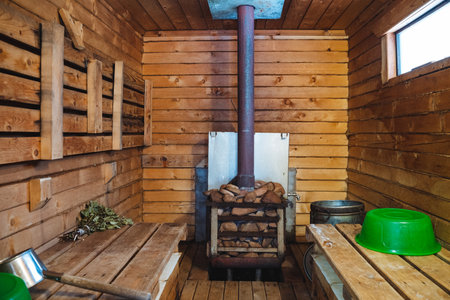 The wooden sauna features a cozy wood stove and aesthetically pleasing green bowls, creating a serene and inviting environment for relaxation and unwinding after a long dayの写真素材
