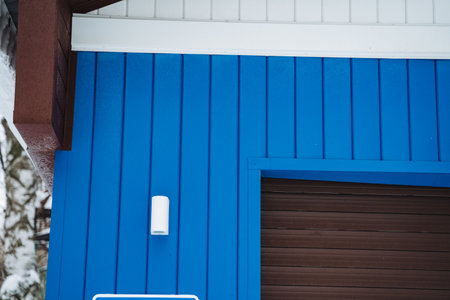 A striking blue building features a no parking sign, enhancing its character. Made of wood and...