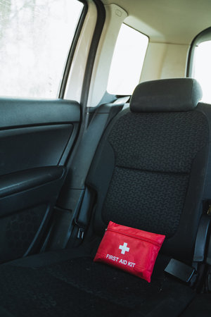 In the back seat of a car, there is a red first aid kit that is nicely organized and easily accessible for any potential emergencies that may arise during your travels or journeysの写真素材