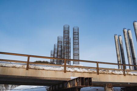 A magnificent bridge is under construction, showcasing its intricate design against a vibrant blue sky, creating a stunning scene that captivates all who pass by this incredible engineering featの写真素材