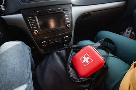 A closeup view of a vibrant red first aid kit, meticulously organized and stored in a car, emphasizes the crucial importance of safety and being wellprepared during travel journeysの写真素材