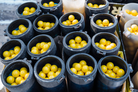 A large collection of black containers that are completely filled to the brim with an abundance of...
