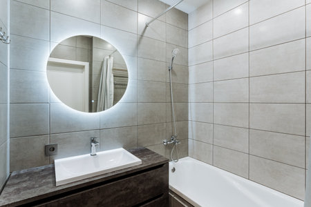 The bathroom features essential elements a functional sink, a spacious bathtub for relaxation, and a...
