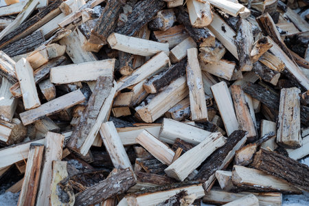 A large pile of wooden planks and logs is currently sitting right on top of another similar pile of...