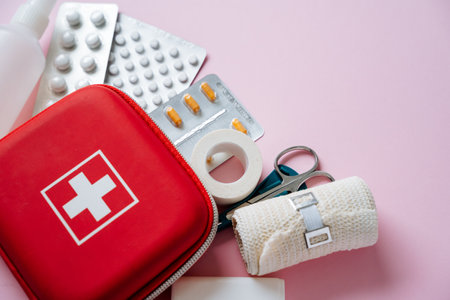 Explore this essential first aid kit featuring bandages, medications, scissors, and more, perfect for emergency preparedness at home or on the goの写真素材