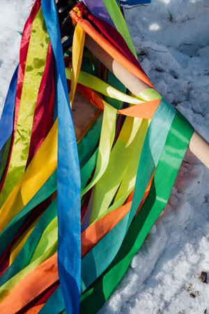 A vibrant assortment of colorful ribbons is strewn across the glistening snow, creating a beautiful contrast against the white backdrop, showcasing shades of blue, green, yellow, and moreの写真素材