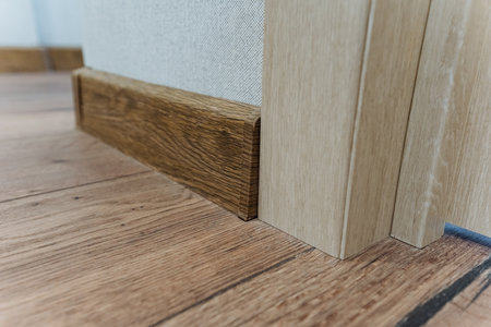 The room features an elegant wooden floor and stylish skirting board, complemented by a beautifully...