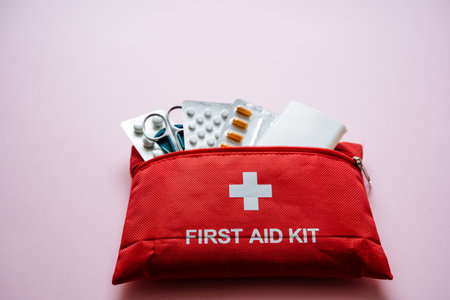 This vibrant red first aid kit is stocked with essential supplies for emergencies, ensuring safety and preparedness at home and during travels, making it an invaluable resourceの写真素材