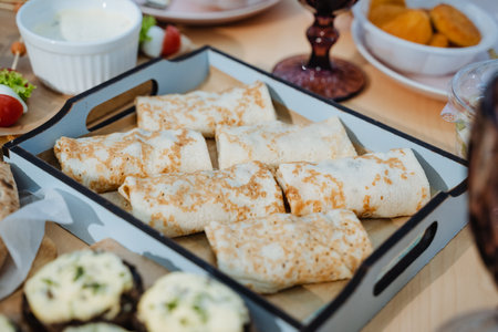 A tray filled with a variety of delicious food items is currently resting on a rustic wooden table, creating an inviting atmosphere for a meal. It showcases diverse culinary delightsの写真素材