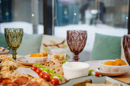 A beautifully arranged table that is topped with an array of delicious plates of food, complemented...