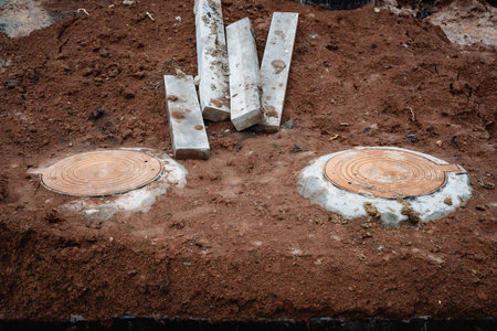 A large assortment of heavy concrete blocks is resting on top of an encompassing pile of dirt, creating an interesting contrast between the manmade and natural elements in the environmentの写真素材
