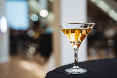 This is an upclose and detailed view of a wonderfully crafted martini glass, which is resting elegantly on a table, perfectly showcasing its stunning design as well as the delightful drink inside itの写真素材