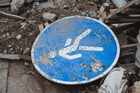 There is a clearly visible blue and white sign that prominently showcases an arrow design which is pointing to the right, effectively directing attention toward that specific direction for passersbyの写真素材