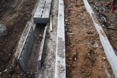 Construction is currently underway for a concrete drain, which is being built along the side of a...