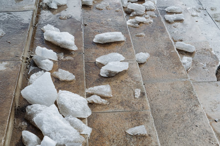 A diverse collection of different types of rocks is scattered across a set of stairs, creating an...