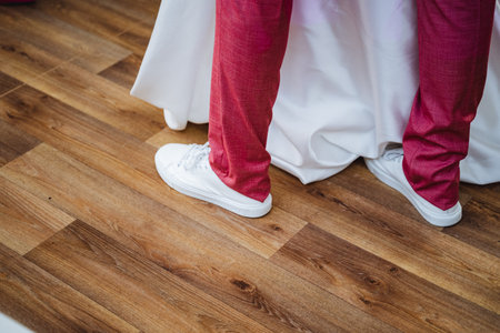 A couple of individuals are standing closely next to each other on a beautifully crafted wooden...