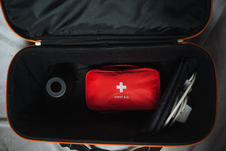 An open suitcase that contains a wellorganized first aid kit within it, ready for any medical emergencies that may arise during travel, complete with all essential supplies and itemsの写真素材