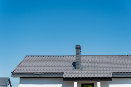 This charming house features a delightful chimney framed by a stunning blue sky, enhancing the...