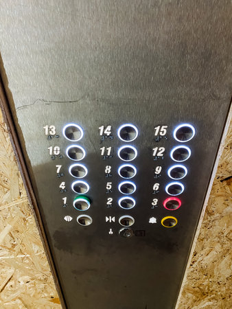A detailed closeup view of a set of elevator buttons, prominently featuring the number 13 on one of...