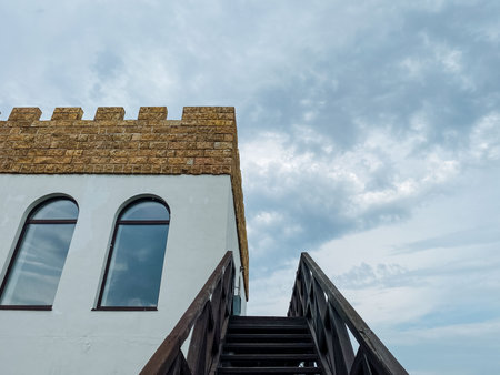A striking white building featuring elegant arched windows and a beautiful staircase leading up to its entrance, providing accessibility for visitors and adding to its aesthetic appealの写真素材