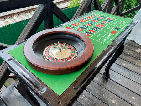 A colorful roulette wheel is meticulously positioned atop a beautifully polished wooden table, creating an inviting atmosphere for an exciting game of chance and strategic decisionmakingの写真素材