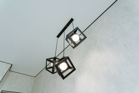 Explore the stunning array of modern geometric pendant lighting that enhances contemporary interiors, adding an inviting ambiance while showcasing your unique style and sophisticationの写真素材