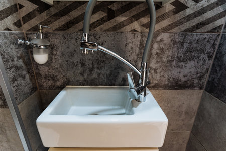 This contemporary square bathroom sink, paired with a sleek chrome faucet, significantly enhances both elegance and functionality, making it a perfect choice for your upcoming renovation projectの写真素材