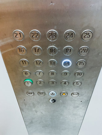This image showcases a detailed closeup view of an elevators control panel, particularly highlighting the button with the number 21 positioned prominently at the top of the panelの写真素材