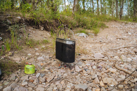 On the ground, a radio is resting beside a green gas cylinder, which adds an interesting element to the scene, while surrounding it are various materials like soil, rubble, and even litterの写真素材
